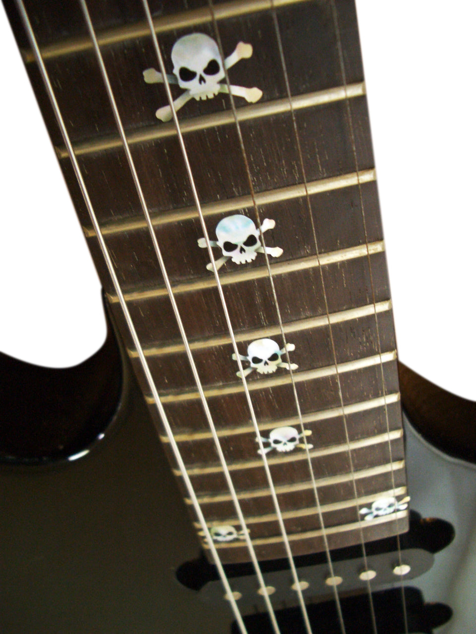 Close-up of a guitar neck with skull and crossbones inlays