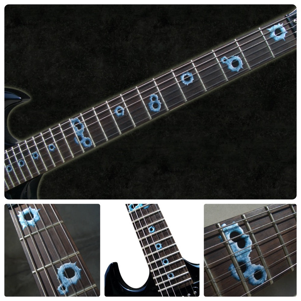 Close-up of a guitar neck with bullet inlays