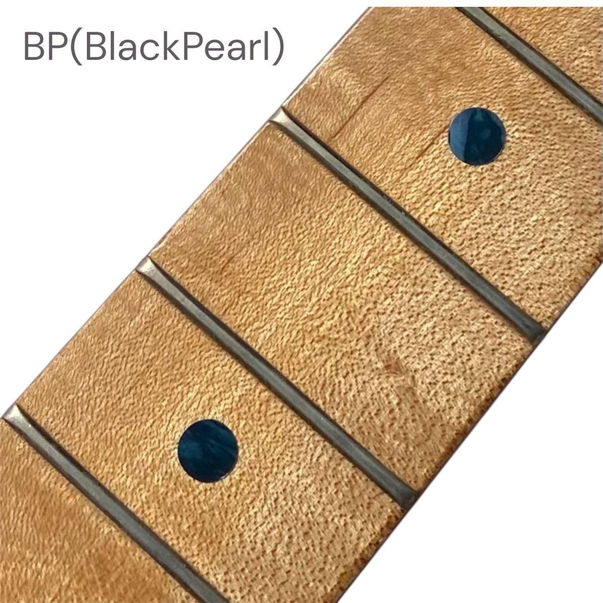 Close-up of a guitar fretboard with black pearl dot inlay stickers