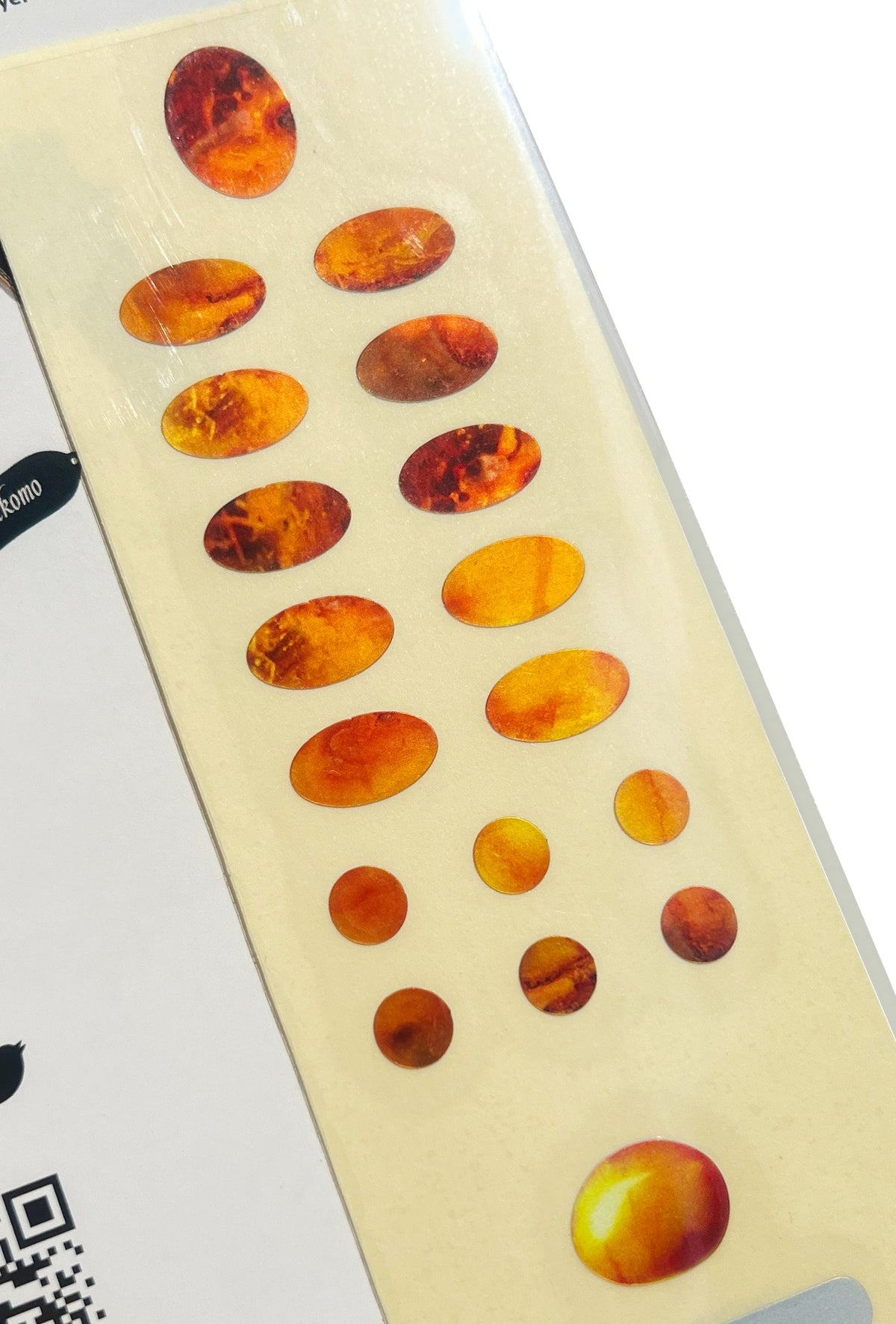 Sheet of amber-colored oval stickers