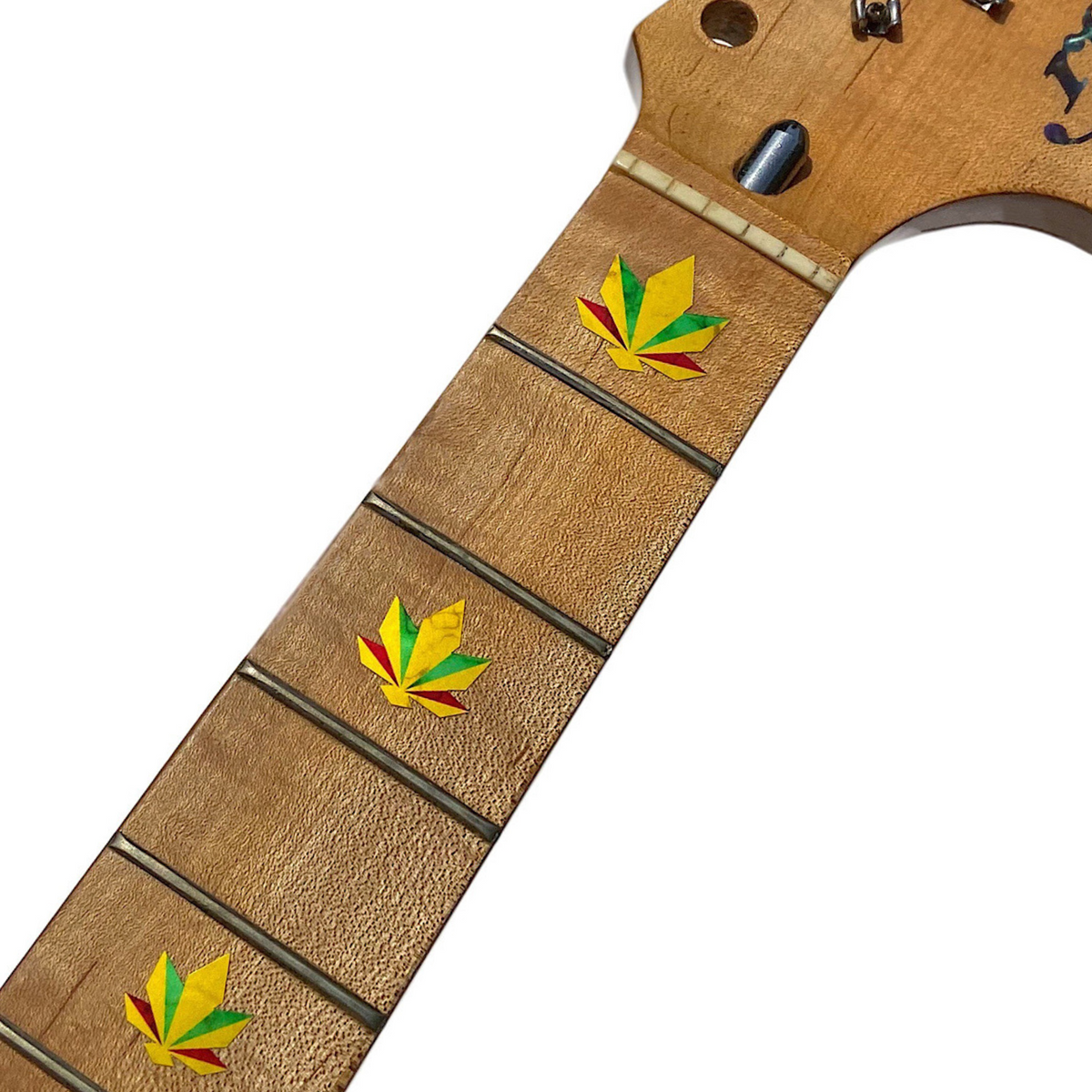 Rasta Color Cannabis Leaf Inlay Stickers applied on a Maple fretboard